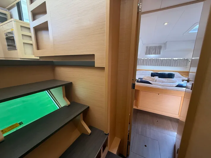 La Mer Yacht Photos Pics Interior of 2020 Lagoon 42 yacht showing stairs and cozy bedroom.