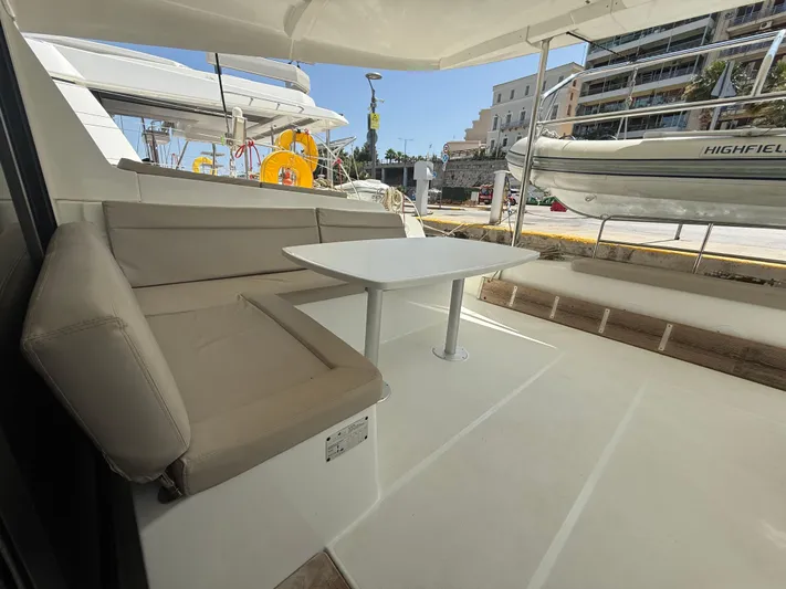 La Mer Yacht Photos Pics Lagoon 42 catamaran interior with beige seating and table, docked at a marina, 2020 model.