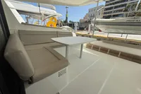 Lagoon 42 catamaran interior with beige seating and table, docked at a marina, 2020 model.