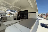 2020 Lagoon 42 catamaran deck with seating and table, docked in a marina.
