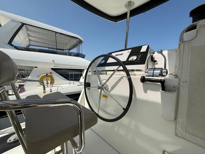 La Mer Yacht Photos Pics Helm of 2020 Lagoon 42 catamaran with steering wheel and navigation controls.
