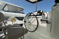 Helm of 2020 Lagoon 42 catamaran with steering wheel and navigation controls.