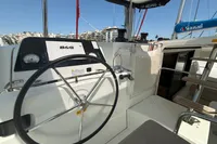 Helm of 2020 Lagoon 42 catamaran with B&G navigation system, docked in marina.
