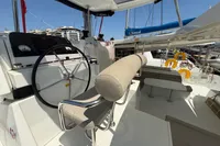 Helm of 2020 Lagoon 42 catamaran with seating and navigation equipment in marina.