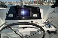 Steering console of a 2020 Lagoon 42 catamaran with navigation instruments and controls.