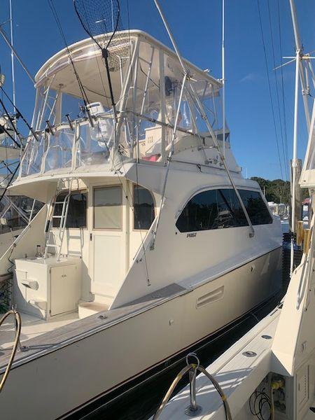 1984 Post Convertible yacht docked, showcasing sleek design and spacious upper deck.