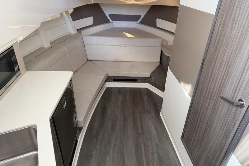  Yacht Photos Pics 2023 Sea Ray Sundancer 370 Outboard cabin interior with modern seating and kitchenette.