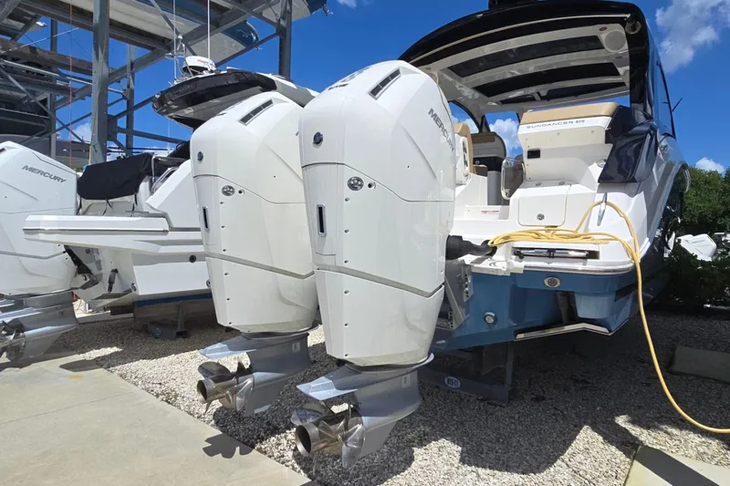  Yacht Photos Pics 2023 Sea Ray Sundancer 370 Outboard with dual Mercury engines, docked under clear skies.