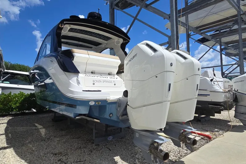  Yacht Photos Pics 2023 Sea Ray Sundancer 370 Outboard with dual Mercury engines, docked under blue sky.