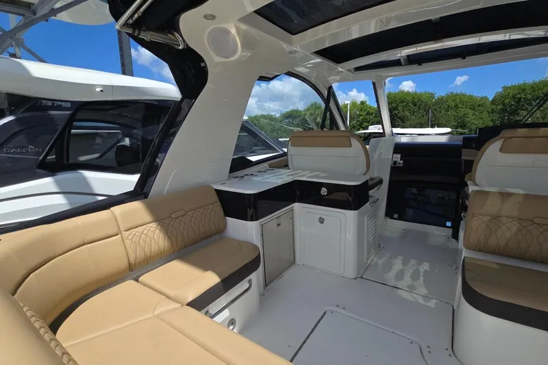  Yacht Photos Pics 2023 Sea Ray Sundancer 370 Outboard interior with beige seating and modern design.