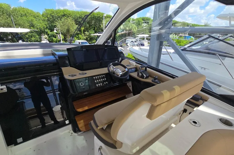  Yacht Photos Pics 2023 Sea Ray Sundancer 370 Outboard helm with modern controls and luxurious seating.