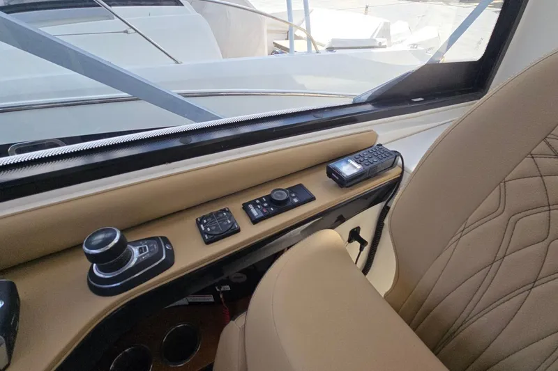  Yacht Photos Pics 2023 Sea Ray Sundancer 370 Outboard helm with controls and beige seating.