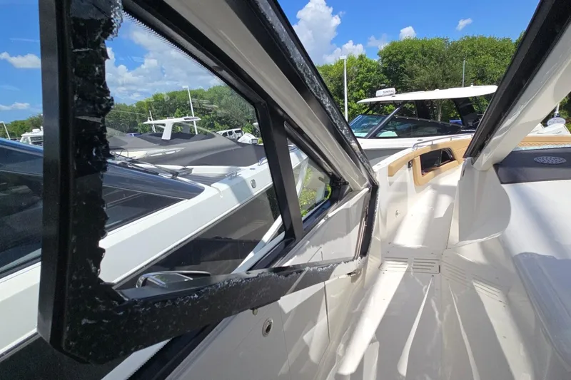  Yacht Photos Pics 2023 Sea Ray Sundancer 370 Outboard with broken window, docked under blue sky.