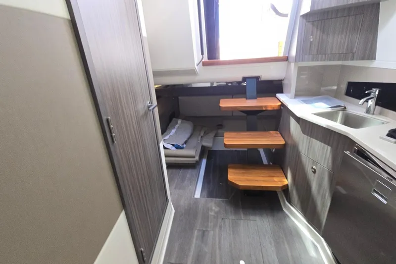  Yacht Photos Pics 2023 Sea Ray Sundancer 370 Outboard interior with modern kitchen and wooden steps.