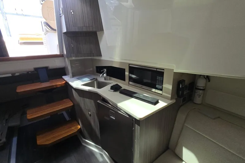  Yacht Photos Pics 2023 Sea Ray Sundancer 370 Outboard interior with kitchenette, microwave, and seating area.