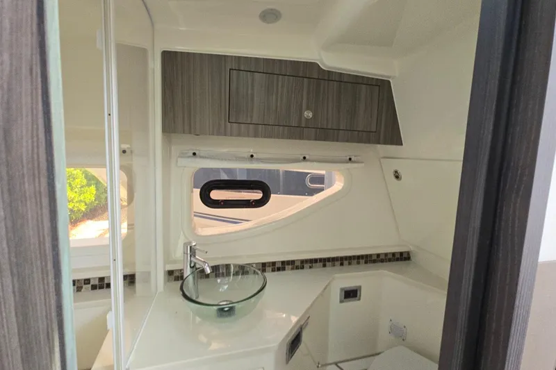  Yacht Photos Pics 2023 Sea Ray Sundancer 370 Outboard bathroom with modern sink and sleek cabinetry.