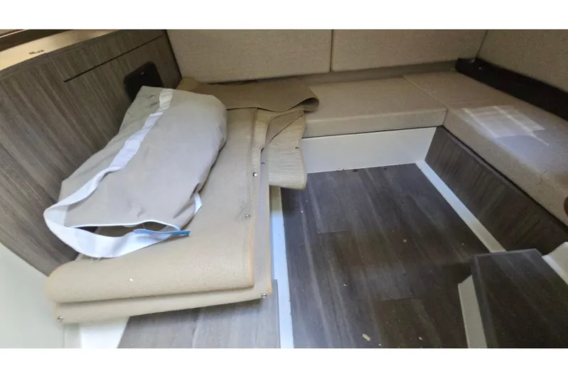  Yacht Photos Pics 2023 Sea Ray Sundancer 370 Outboard interior cabin with wood flooring and beige seating.