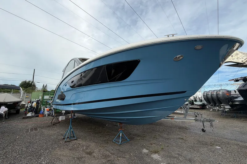  Yacht Photos Pics 2023 Sea Ray Sundancer 370 Outboard in a boatyard, showcasing sleek blue hull design.