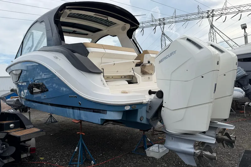  Yacht Photos Pics 2023 Sea Ray Sundancer 370 Outboard with dual Mercury engines, docked on stands.