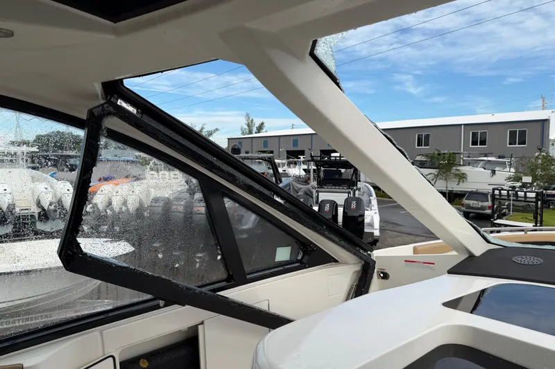  Yacht Photos Pics 2023 Sea Ray Sundancer 370 Outboard interior view with wet windows and marina background.