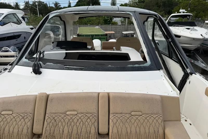  Yacht Photos Pics 2023 Sea Ray Sundancer 370 Outboard with damaged windshield, docked among other boats.
