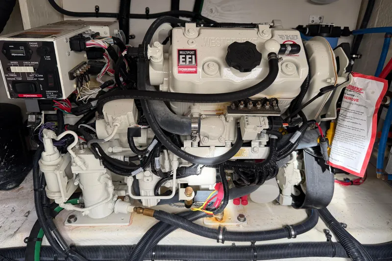  Yacht Photos Pics Engine compartment of 2023 Sea Ray Sundancer 370 Outboard, showcasing complex wiring and components.