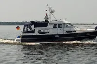 Nimbus 380 Commander 2007 cruising on calm waters with a German flag.