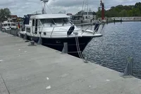 Nimbus 380 Commander 2007 yacht docked at a marina under cloudy skies.