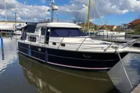 Nimbus 380 Commander 2007 yacht docked in a marina under a partly cloudy sky.