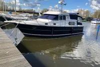 Nimbus 380 Commander 2007 yacht docked in a marina under a partly cloudy sky.