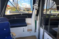 Interior view of 2007 Nimbus 380 Commander yacht with seating and wooden flooring.
