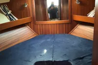 Cozy cabin interior of 2007 Nimbus 380 Commander with blue bedding and wooden accents.