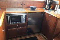 Compact kitchen in 2007 Nimbus 380 Commander with microwave, fridge, and coffee maker.