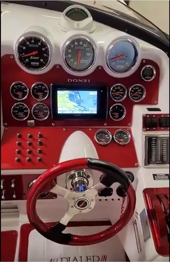  Yacht Photos Pics Dashboard of a 2008 Donzi 35 ZR boat with red accents and navigation display.