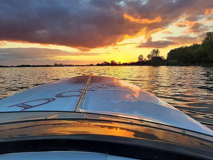  Yacht Photos Pics 2008 Donzi 35 ZR boat on water at sunset, reflecting vibrant sky colors.