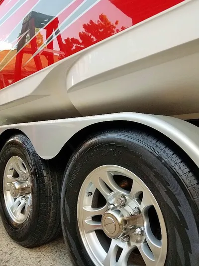  Yacht Photos Pics Close-up of 2008 Donzi 35 ZR boat trailer wheels and red hull.
