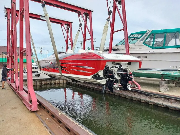  Yacht Photos Pics 2008 Donzi 35 ZR speedboat in dry dock, vibrant red hull, ready for maintenance.