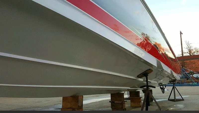  Yacht Photos Pics 2008 Donzi 35 ZR boat hull with red stripe, elevated on blocks.