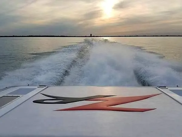  Yacht Photos Pics 2008 Donzi 35 ZR speedboat cruising at sunset, leaving a wake on calm water.
