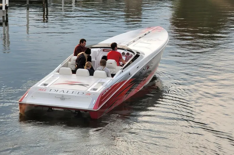  Yacht Photos Pics 2008 Donzi 35 ZR speedboat on water with passengers, featuring sleek design and vibrant graphics.