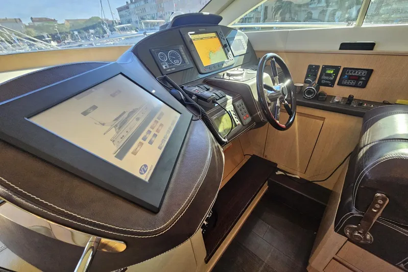 M/y Tivella Yacht Photos Pics Interior of a 2009 VZ 68 yacht cockpit with advanced navigation systems and controls.