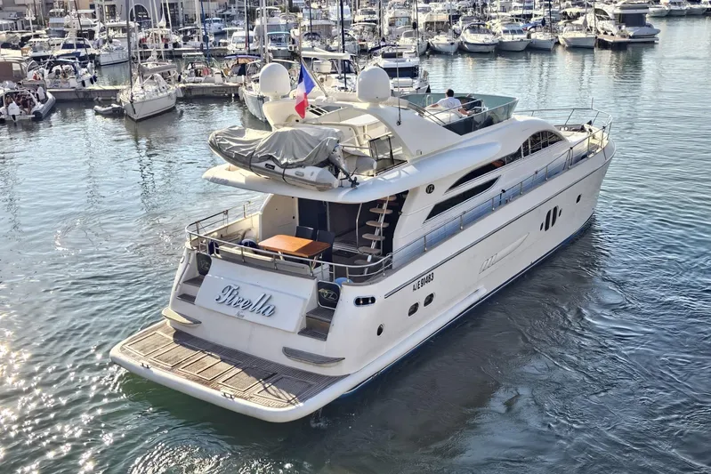 M/y Tivella Yacht Photos Pics Luxurious 2009 VZ 68 yacht docked in a bustling marina, showcasing elegant design.