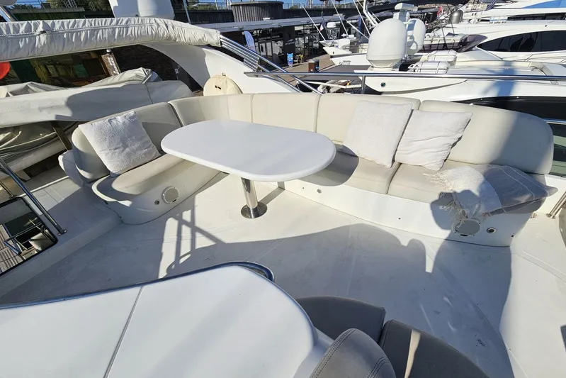 M/y Tivella Yacht Photos Pics Luxurious seating area on a 2009 VZ 68 yacht with white cushions and table.