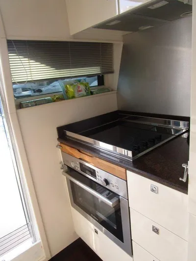 M/y Tivella Yacht Photos Pics Compact kitchen with modern stove and oven in a VZ 68, 2009 model.