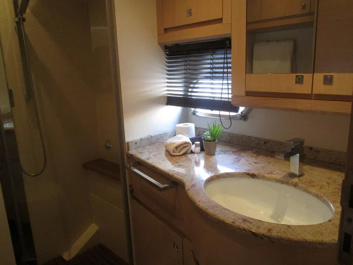 M/y Tivella Yacht Photos Pics Luxurious bathroom in 2009 VZ 68 yacht with granite countertop and modern fixtures.