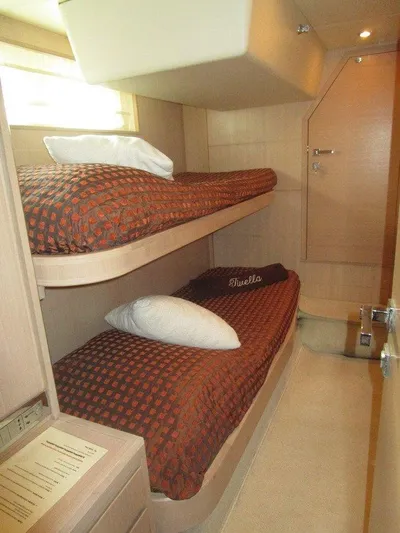 M/y Tivella Yacht Photos Pics Bunk beds in a 2009 VZ 68 yacht cabin with brown bedding and wooden interior.