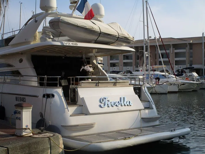M/y Tivella Yacht Photos Pics Luxury yacht VZ 68, 2009 model, docked in a marina with other boats.