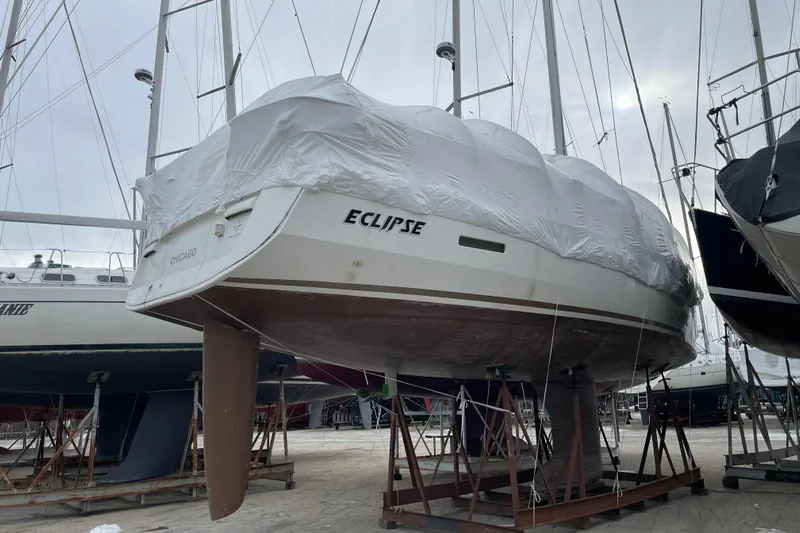 Eclipse Yacht Photos Pics 2014 Jeanneau Sun Odyssey 439 sailboat, named Eclipse, covered and docked in a marina.