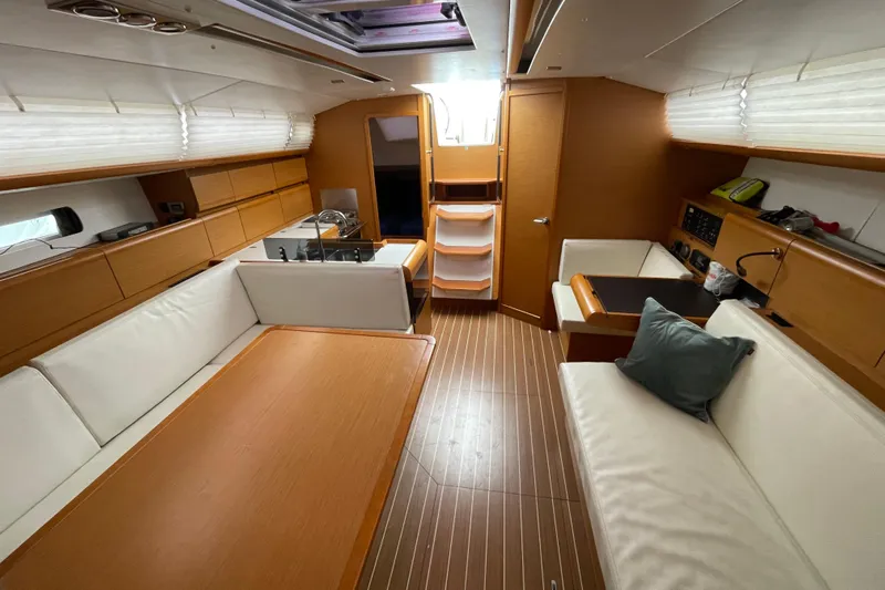 Eclipse Yacht Photos Pics Interior of 2014 Jeanneau Sun Odyssey 439 yacht with modern wood finish and seating.