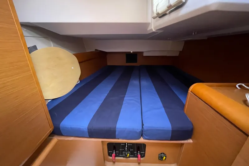Eclipse Yacht Photos Pics Cozy cabin interior of 2014 Jeanneau Sun Odyssey 439 sailboat with striped bedding.